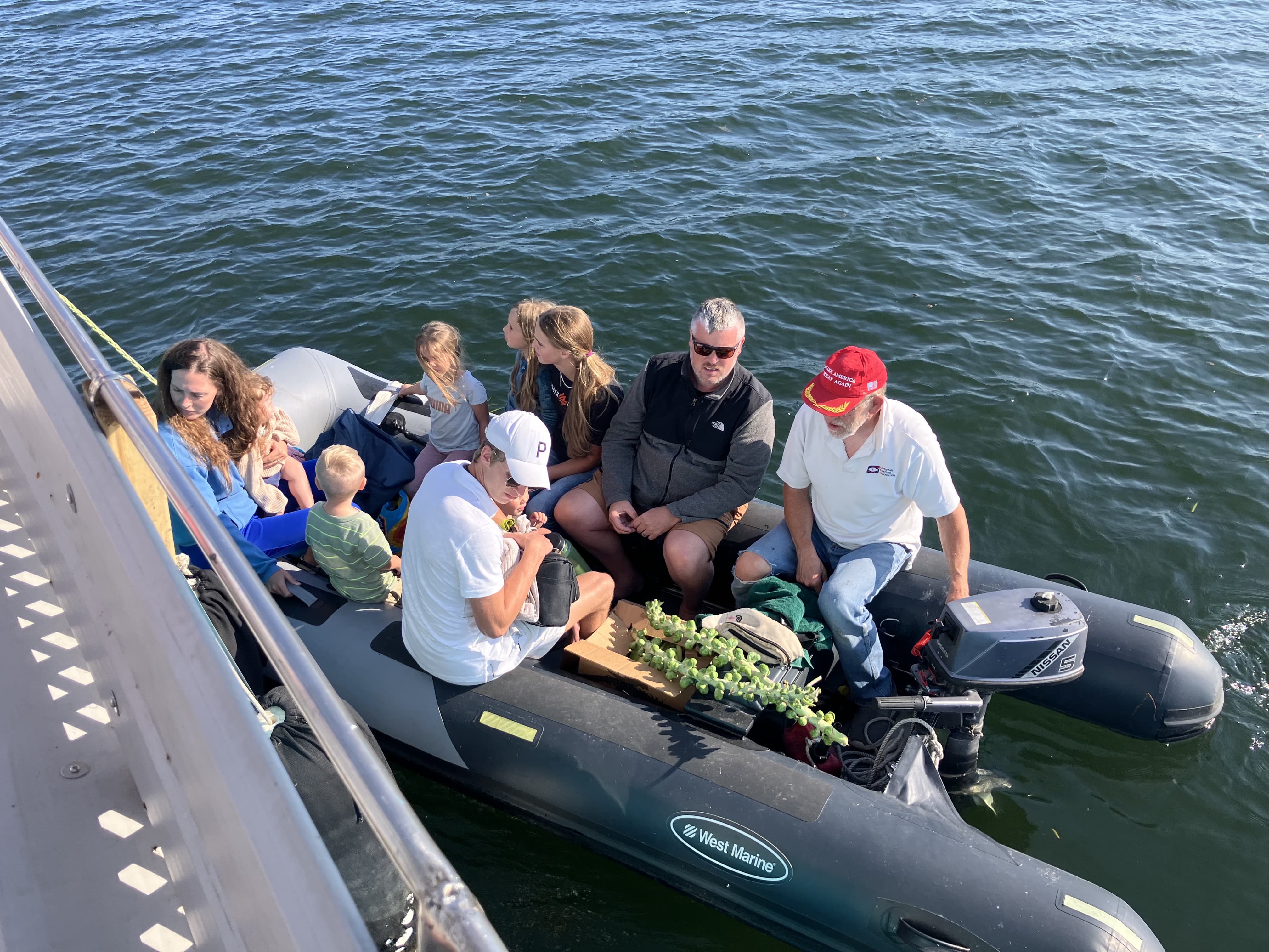 Crew and guests travelling beside the vessel in an inflatable boat